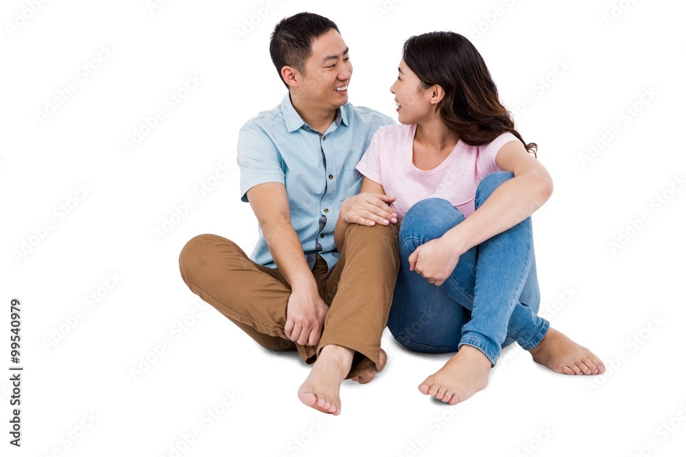 Happy young couple looking at each other while sitting