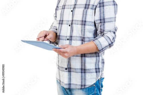 Mid section of man using tablet computer