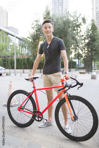 Happy young man and bicycle