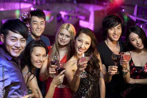 Stylish young people drinking in bar