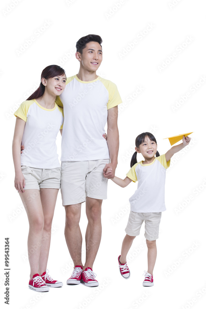 Happy young family playing with paper airplane Happy young family playing with paper airplane