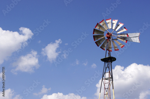 old metal windmill in blue sky