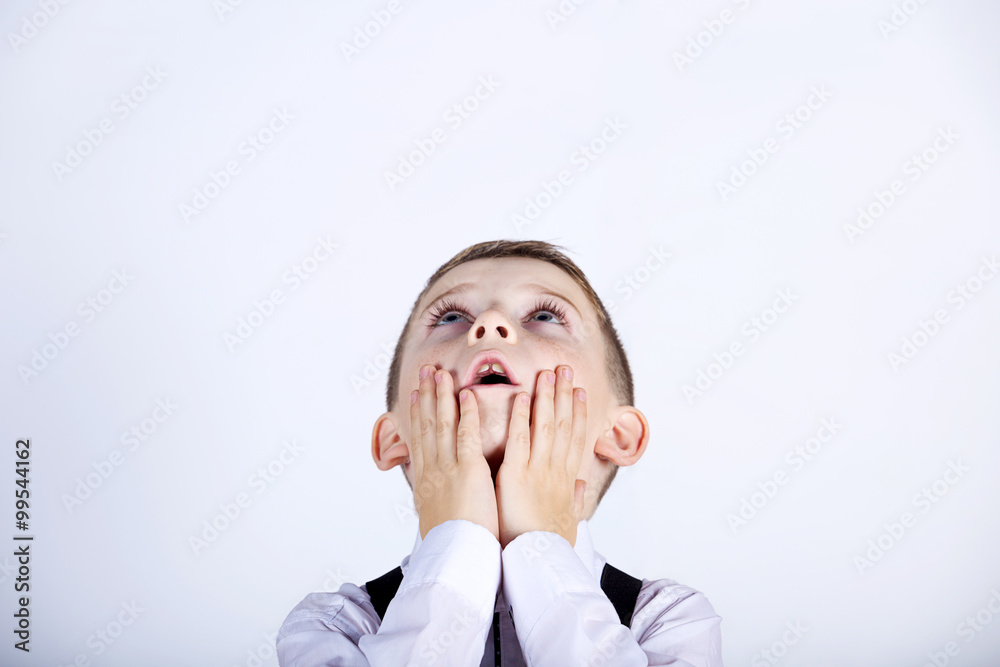 Surprised little boy looking up with mouth open isolated over yellow background. Surprised little boy looking up with mouth open isolated over yellow background.