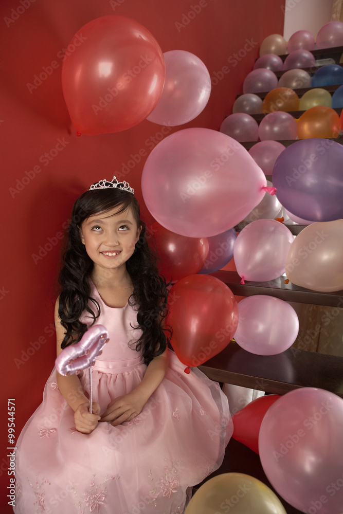 Girl Holding Wand Sitting On Stairs With Balloons