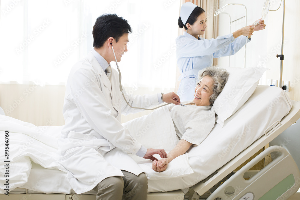 Doctor using stethoscope on patient in hospital Doctor using stethoscope on patient in hospital