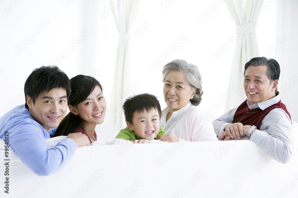 Chinese family turning around and smiling on the living room sofa Chinese family turning around and smiling on the living room sofa