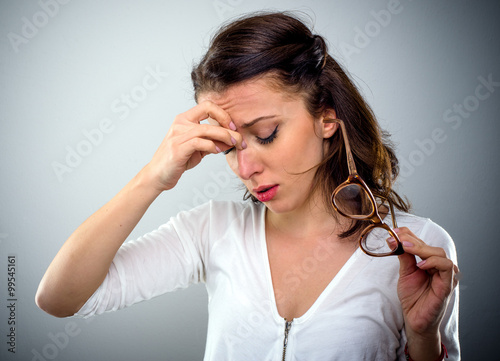 Attractive young woman with a headache