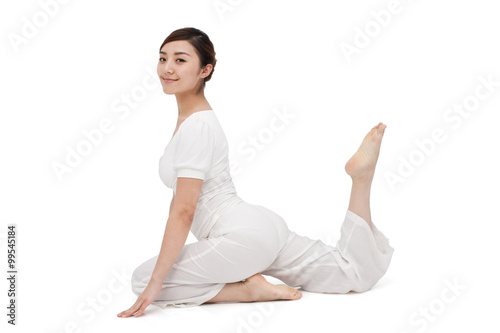 Young woman stretching on the floor © Blue Jean Images
