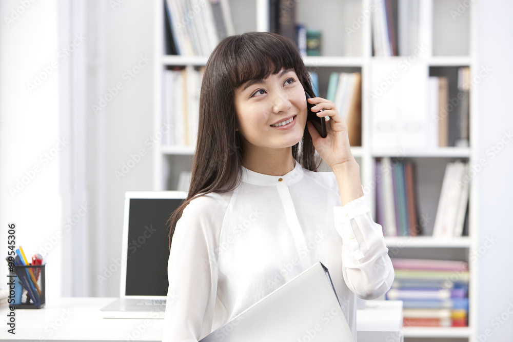 Cheerful young businesswoman on the phone in the office Cheerful young businesswoman on the phone in the office