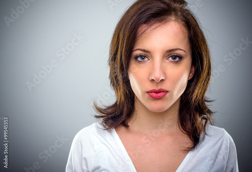 Canvas Print Serious attractive young woman pouting her lips