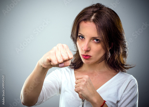 Combative young woman punching at the camera
