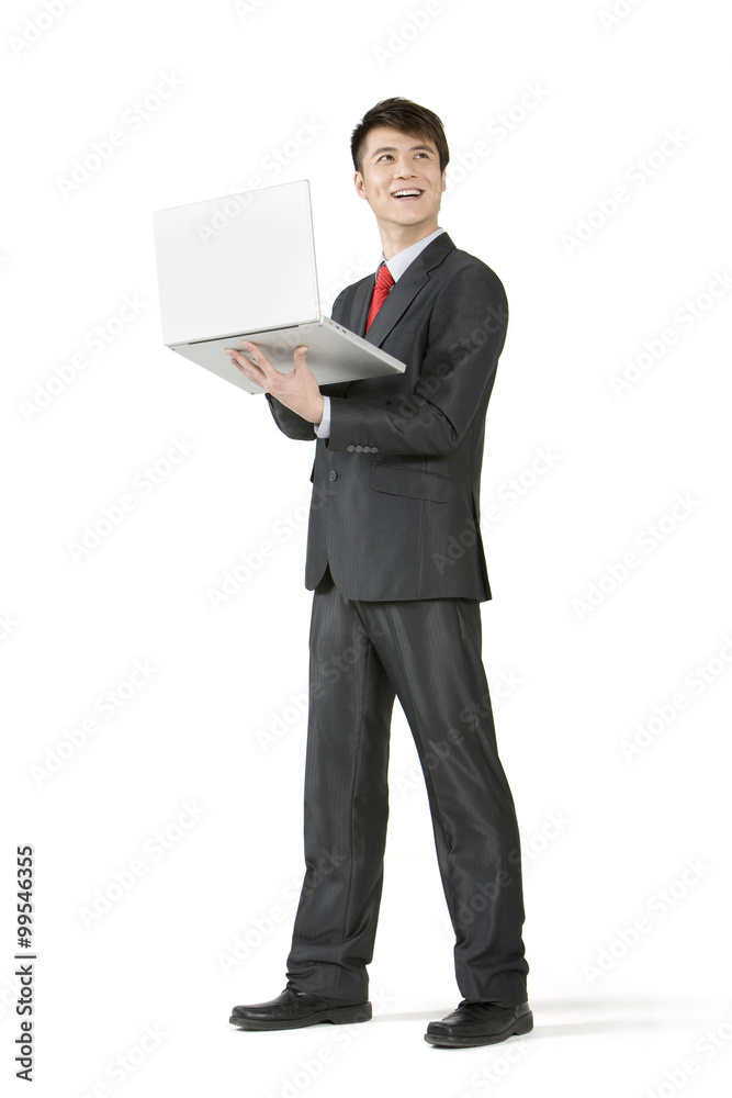 Young businessman holding a laptop Young businessman holding a laptop