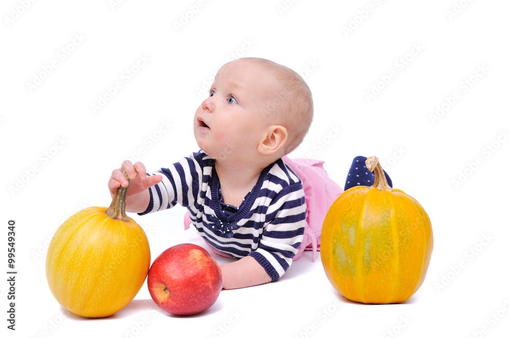 Fototapeta premium child on a white background with pumpkins and apples/charming child with pumpkins and apples; Isolated over White Background
