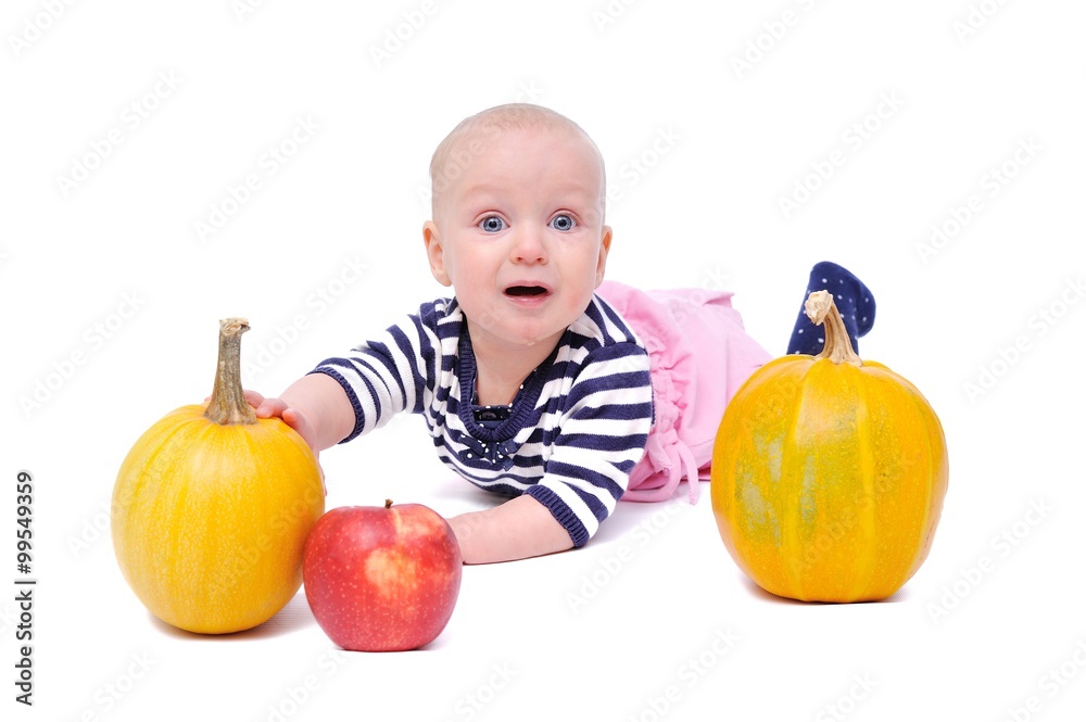 Fototapeta premium child on a white background with pumpkins and apples/charming child with pumpkins and apples; Isolated over White Background