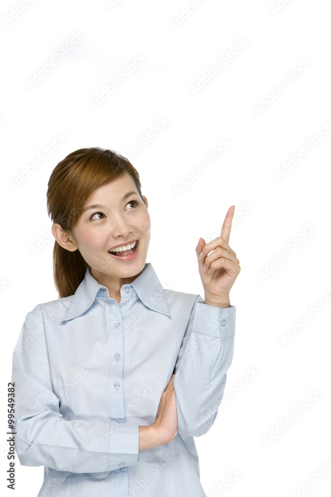 Smiling young businesswoman pointing her finger Smiling young businesswoman pointing her finger