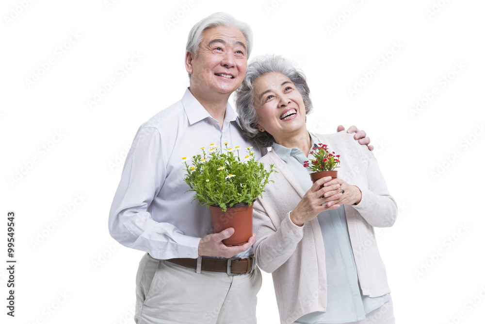Happy senior couple with potted plants Happy senior couple with potted plants