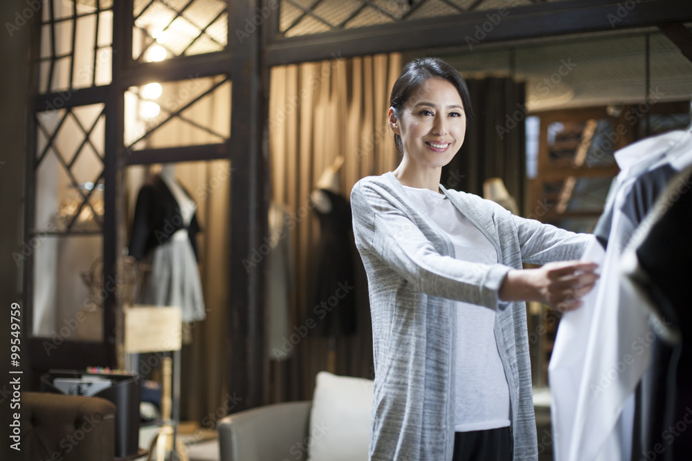 Obraz premium Clothing store owner checking clothes
