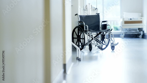 Professional wheelchair for disabled patient in medical centre corridor photo
