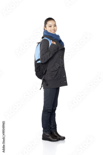 A young female student wearing a backpack, white background