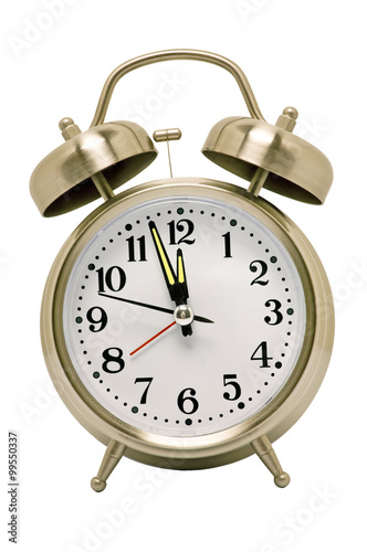 Alarm Clock/ Vertical shot of a brushed brass alarm clock with glow in the dark hands on white background