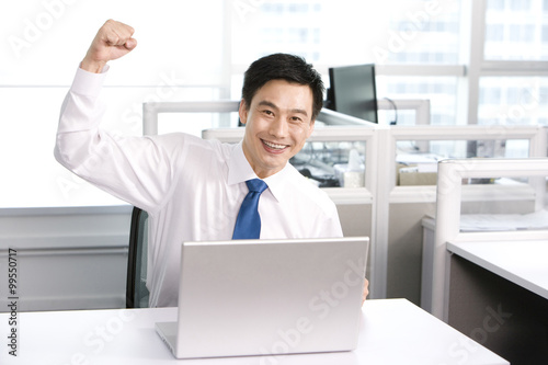 Happy office worker at his desk