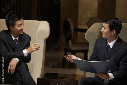 Photography Two business leaders discuss cooperation at an exclusive business club