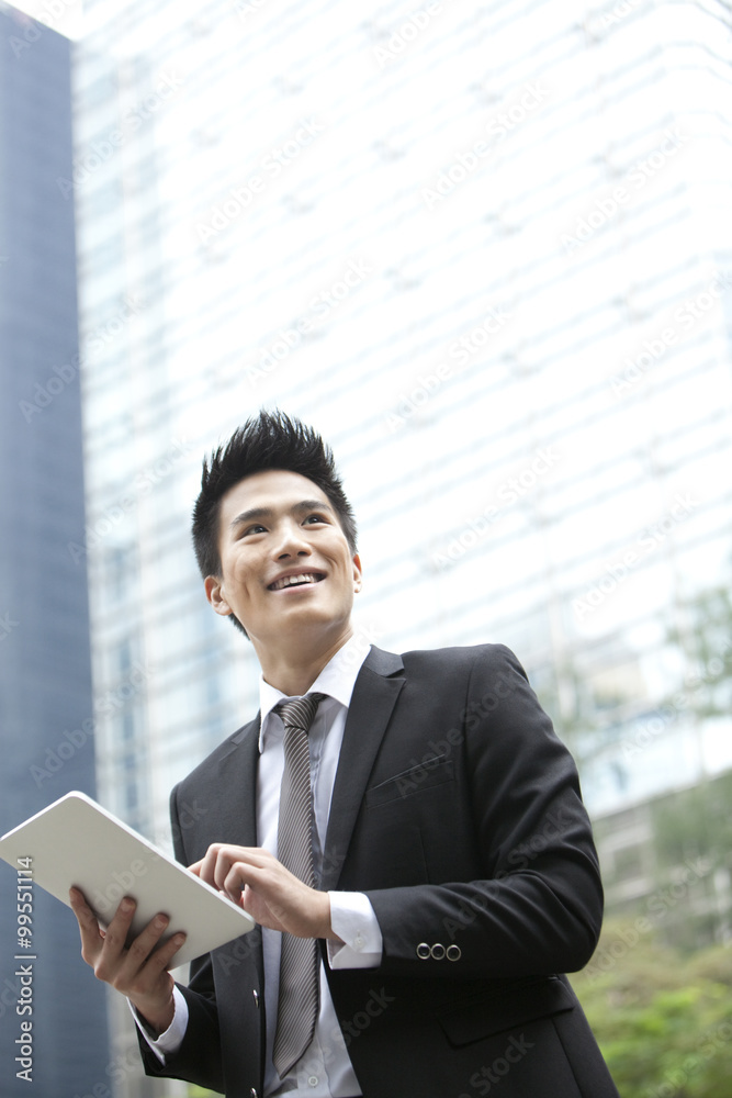 Professional businessman with digital tablet, Hong Kong Professional businessman with digital tablet, Hong Kong