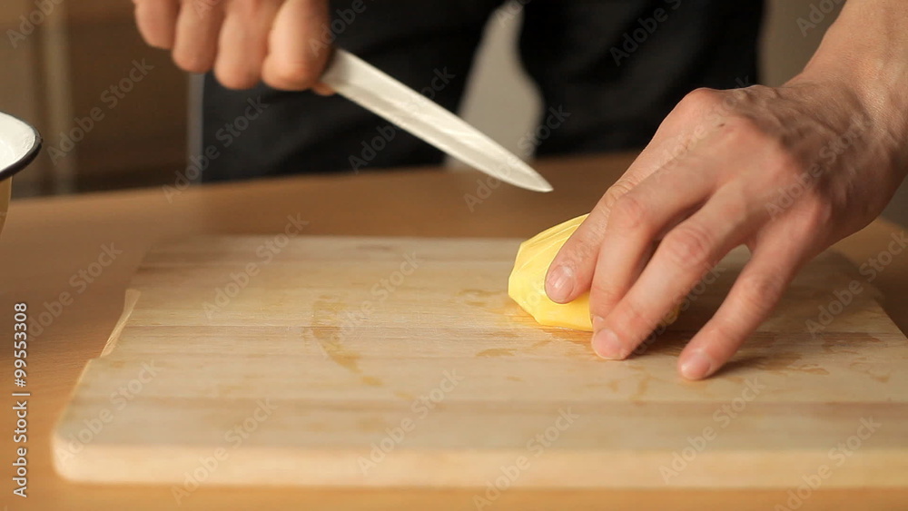 man cut potatoes in the kitchen