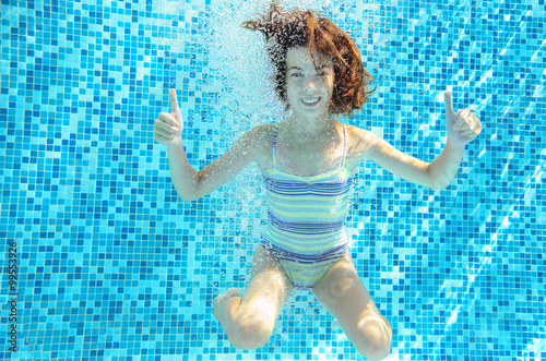 Girl jumps  dives and swims in pool underwater  happy active child has fun under water