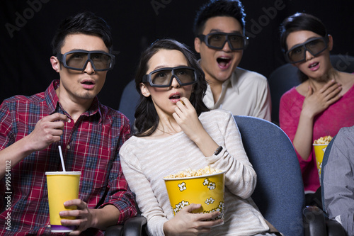 Young couple watching 3D movie in cinema