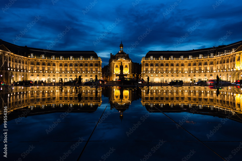 Historical building in Bordeaux reflected in a water pond
