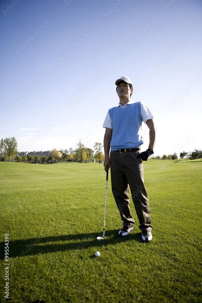 Golfer standing on the golf course Golfer standing on the golf course