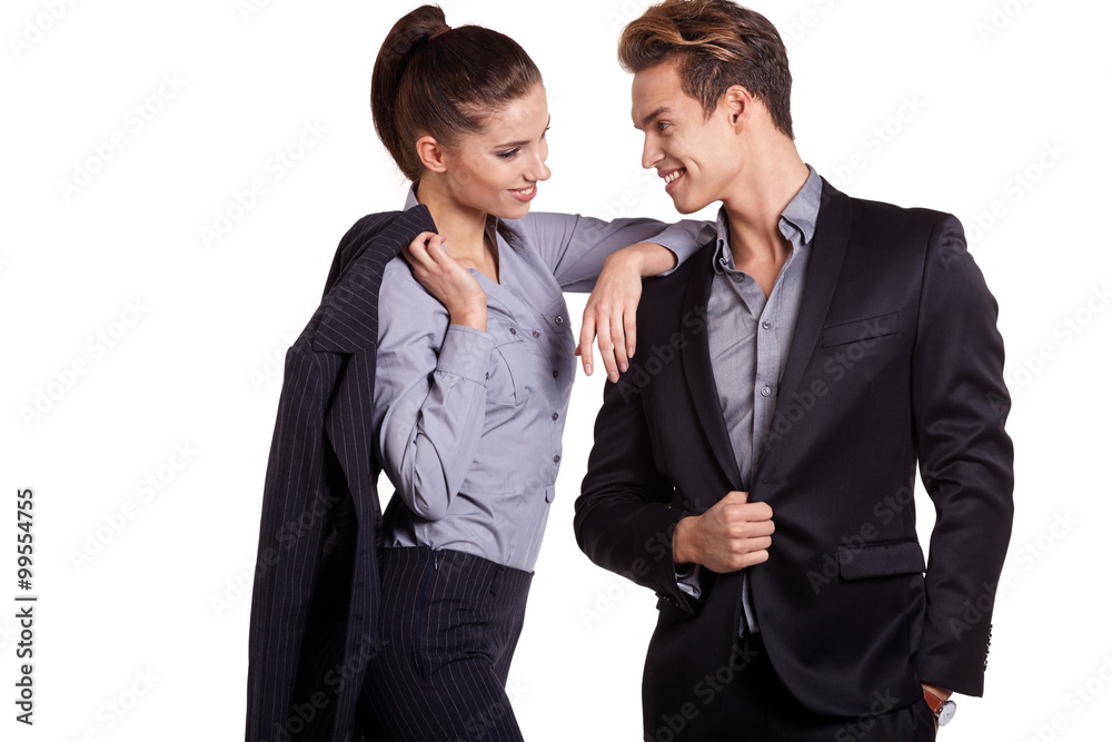 Successful business couple is standing on isolated background. Successful business couple is standing on isolated background.
