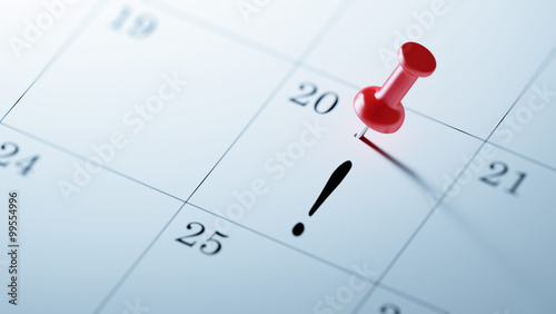 Concept image of a Calendar with a red push pin. Closeup shot of