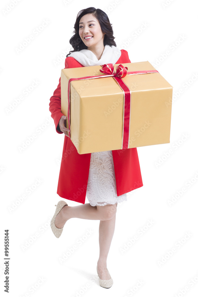Happy young woman holding a large gift Happy young woman holding a large gift