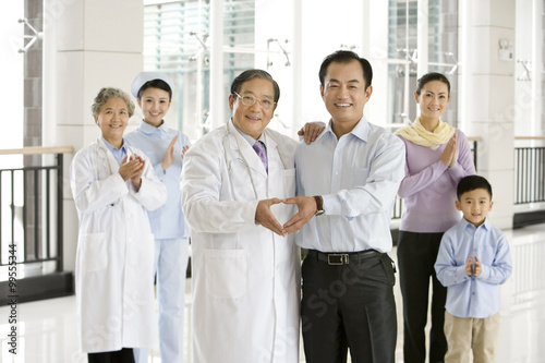 Father Makes a Heart Shape With Hands With Senior Doctor photo