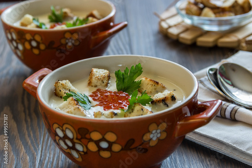 cheese soup puree with croutons and red caviar