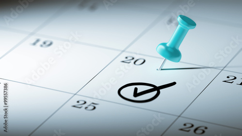 Concept image of a Calendar with a blue push pin. Closeup shot o