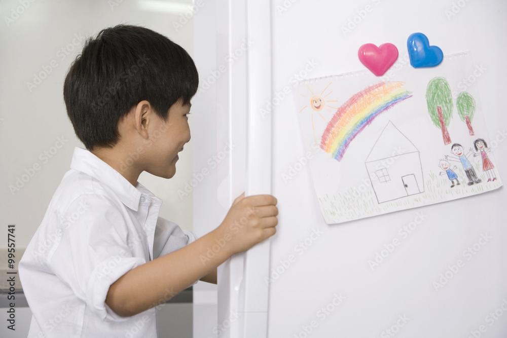 Young boy opening refrigerator Young boy opening refrigerator