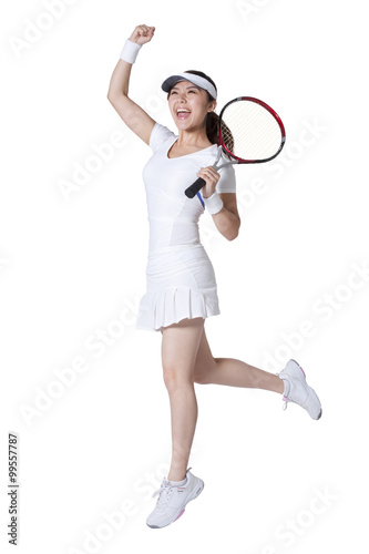 Young woman playing tennis and cheering © Blue Jean Images