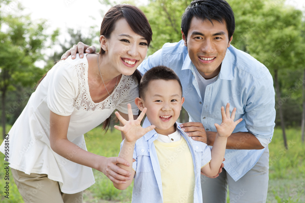 Portrait of young family on grass Portrait of young family on grass