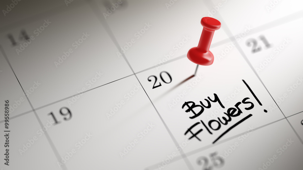 Concept image of a Calendar with a red push pin. Closeup shot of