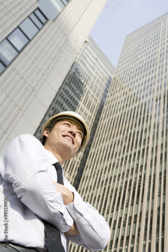 Businessman standing in front of skyscraper