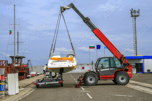 Crane lifts a boat