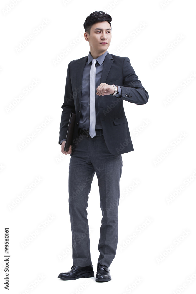 Businessman checking the time on wristwatch Businessman checking the time on wristwatch