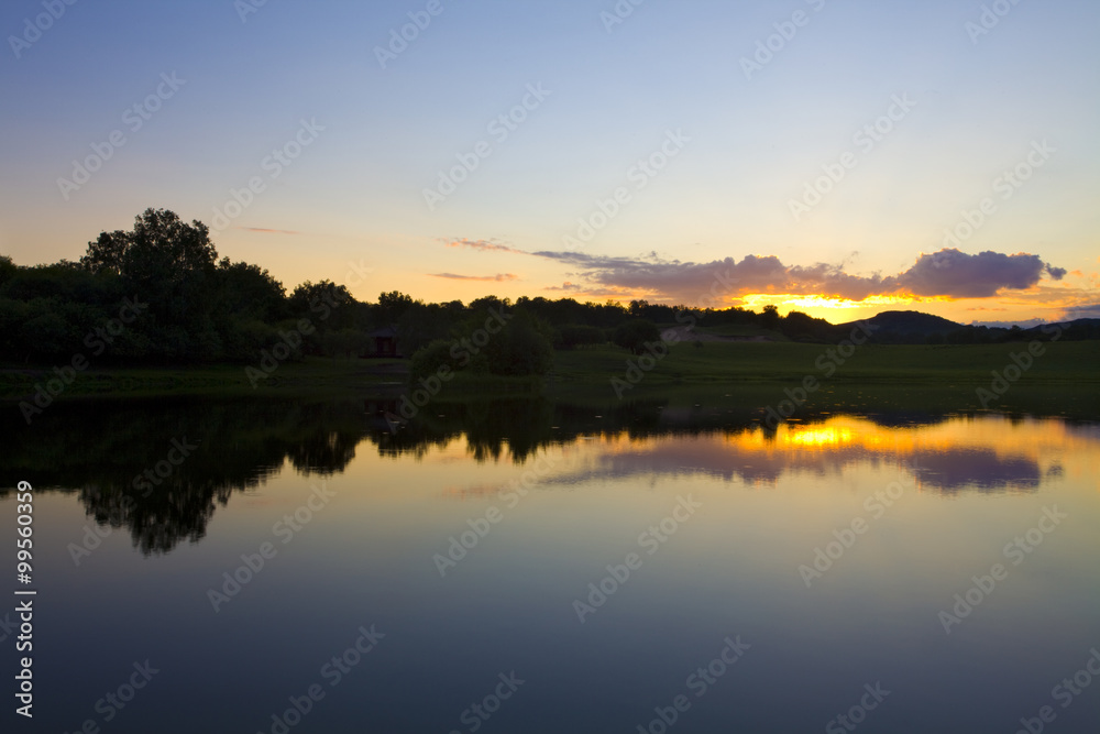 Sun rising over a small lake