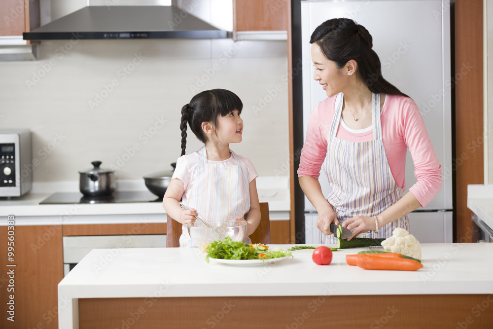 Mother and daughter preparing meal