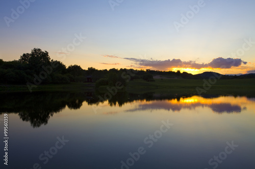 Fototapeta Naklejka Na Ścianę i Meble -  Sun rising over a small lake