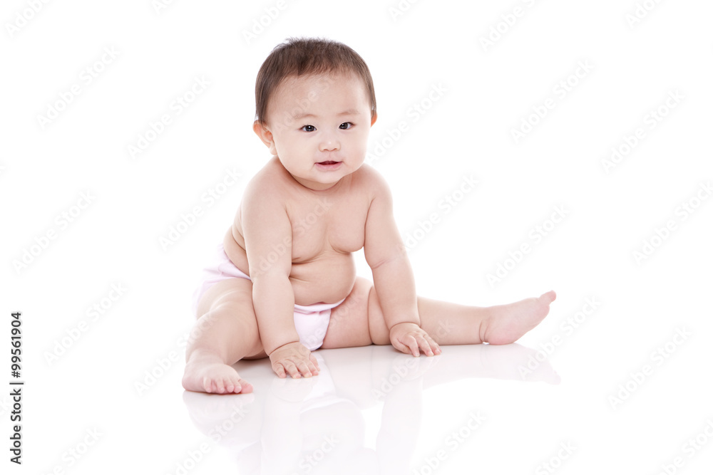Studio shot of cute baby sitting on floor Studio shot of cute baby sitting on floor