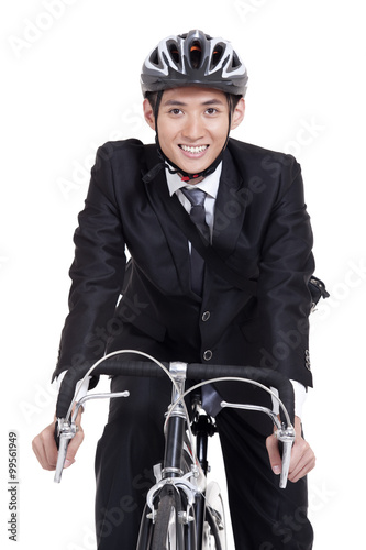 Portrait of young businessman riding a bike